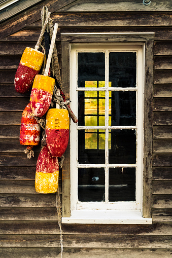 Rustic fishing shack in Maine with lobster buoys