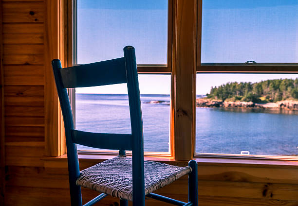 Looking through rustic window from a peaceful room in Maine with a view of the ocean