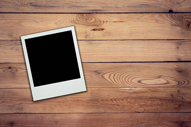 istock Blank photo frame on wood background and texture 609729746