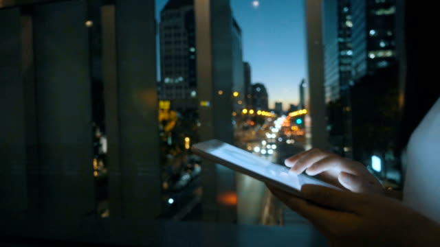 Woman using Digital Tablet at night