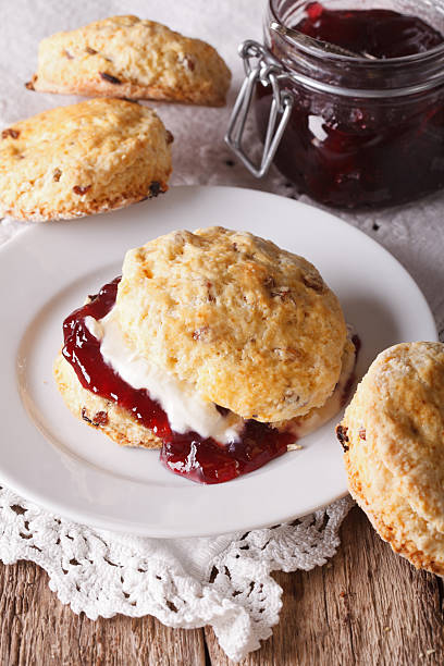 istock British scones with jam and whipped cream close-up. vertical 609791300