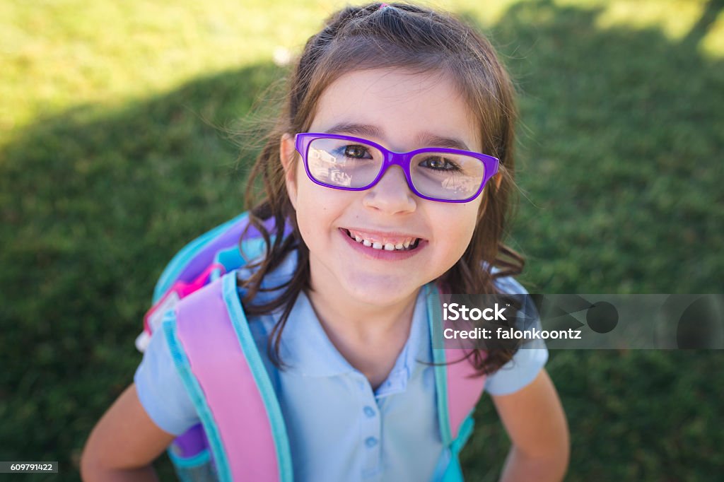 First Day of School A girl wearing a uniform and a backpack is ready for her first day of school. Child Stock Photo