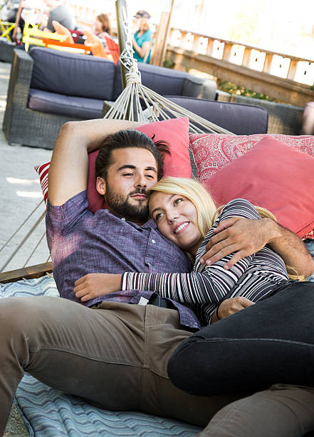 istock Young Couple Relaxing in Urban Public Park Hammock 609791778