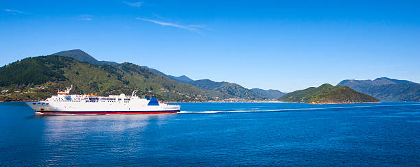Ferry on Queen Charlotte Sound of Cook Strait, New Zealand Ferry on Queen Charlotte Sound of the Cook Strait with the town of Picton, New Zealand in the background. picton new zealand stock pictures, royalty-free photos & images