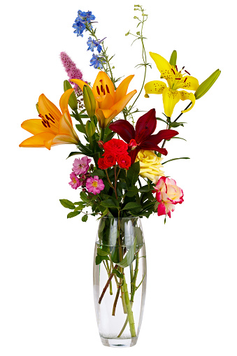 Blooming bouquet of flowers in a transparent vase with water. Isolated on white background.