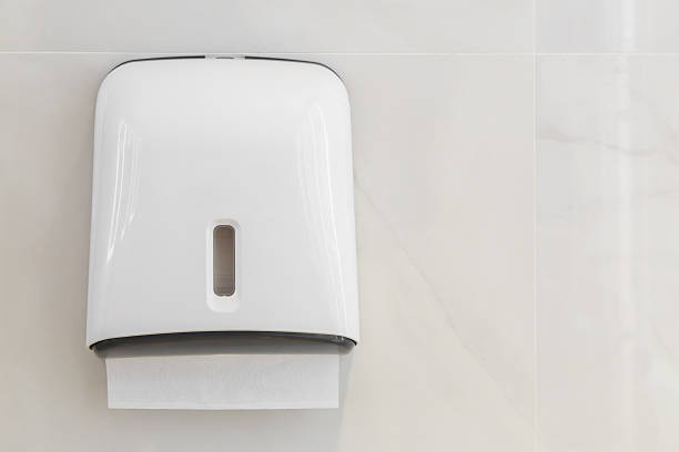 Soft focus tissues paper towel dispenser on granite wall Soft focus tissues paper towel dispenser on granite wall in barthroom change dispenser stock pictures, royalty-free photos & images