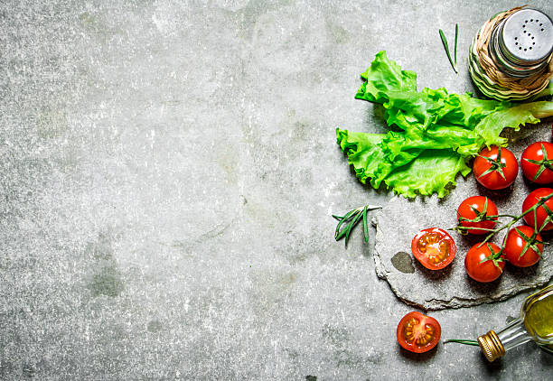 istock Fresh tomatoes with lettuce and olive oil. 609794600