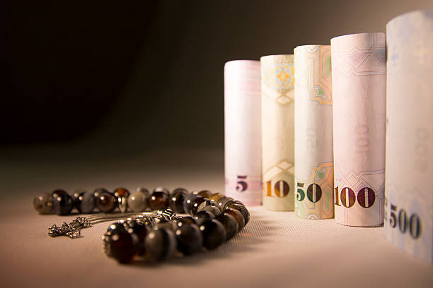 twisted cash money with rosary, gift for eid - sharia imagens e fotografias de stock