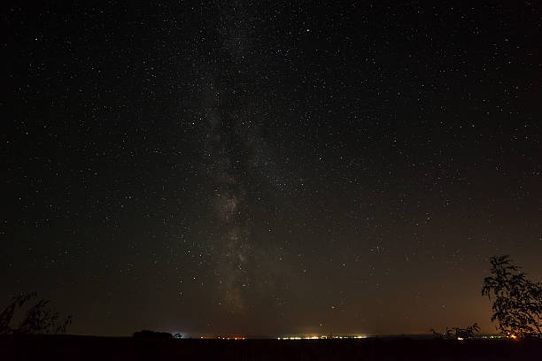 istock Bright stars in the night sky above  city 609796096