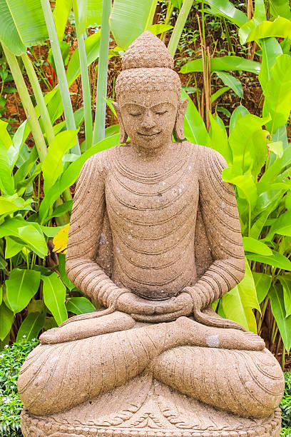 istock Stone Buddha statue (indonesian style) in garden 609796766