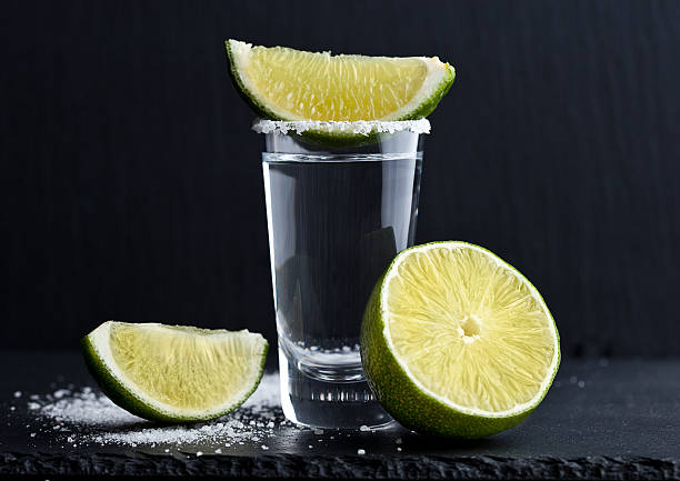tequila silver shot with lime slices and salt - tequila shot imagens e fotografias de stock