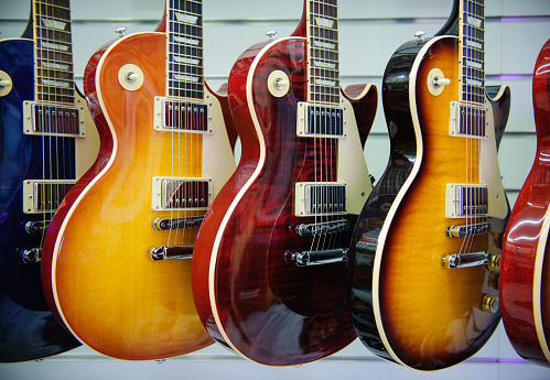 Rome, Italy. September 20th 2016.  Gibson Les Paul electric guitars sunburst colors in a store showroom, body detail. Guitars hanging at the wall