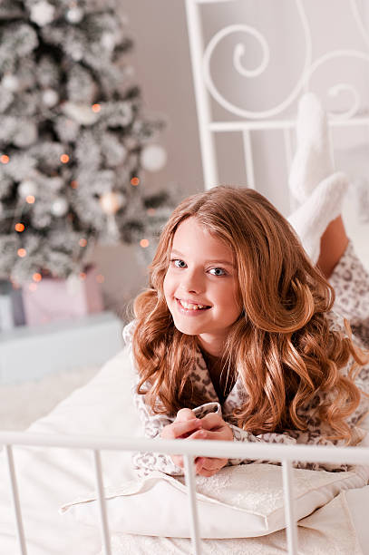 istock Happy girl over christmas tree 609798460