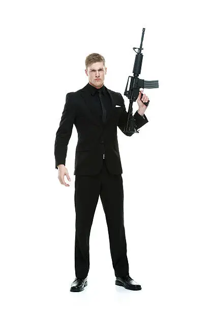 Photo of Angry businessman holding rifle