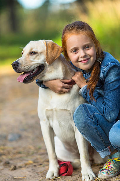 istock Little girl on a walk with the dog. 609799350