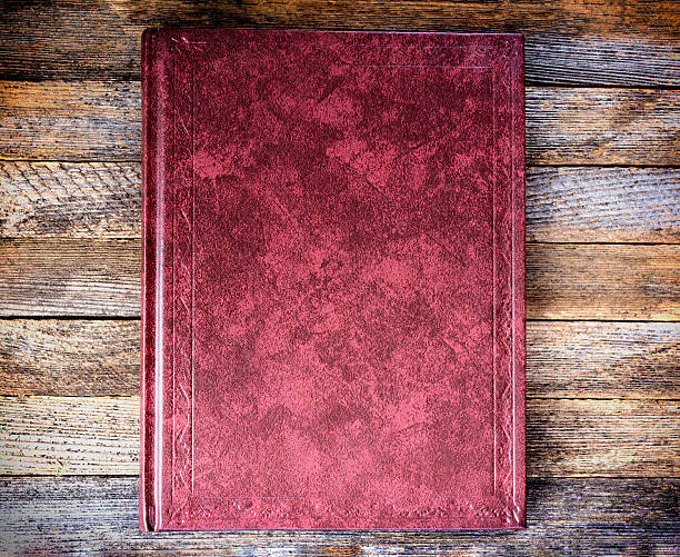 istock book is red on the old wooden boards close up 609799424