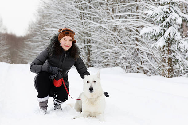 istock Woman with white swiss shepherd dog 609799820