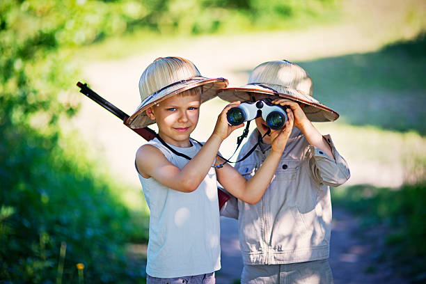 istock Happy little safari boys exploring widerness 609799858