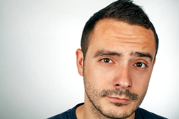 istock Portrait of a doubtful young man 609800170
