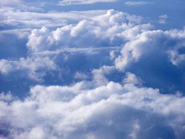 istock On top of fluffy curvy spaced clouds 609801686