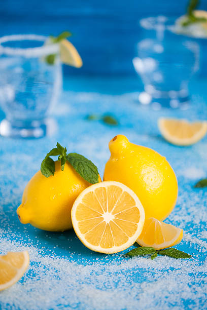 istock Lemon on the blue wood table with mint, sugar, drinks 609802232