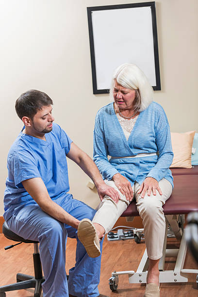 istock Mature woman with physical therapist 609804996