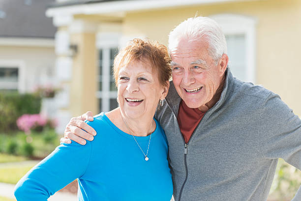 istock Loving senior couple standing outside home 609805036