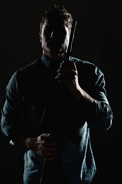 istock Casual man in action with rifle 609806468