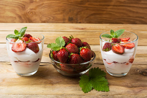 istock Cream dessert with strawberries on dark wooden background 609809130