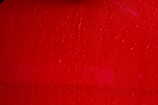 istock Drop of water on red car 609811398