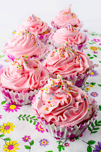 istock Pink birthday cupcakes  with whipped cream 609813986