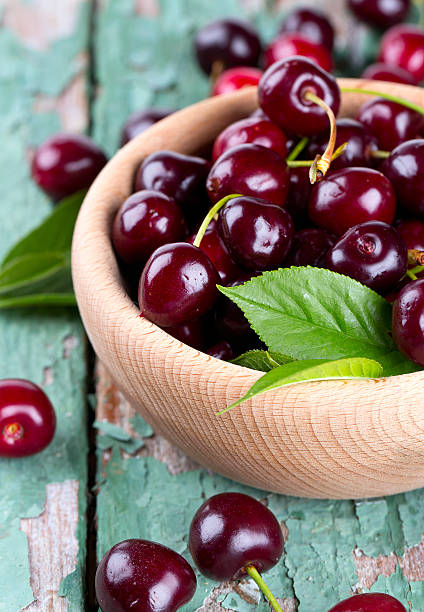 istock cherries in a bowl on wooden surface 609814814