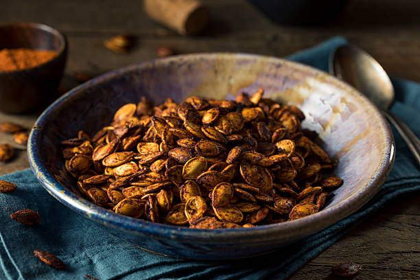 Homemade Roasted Spicy Pumpkin Seeds Homemade Roasted Spicy Pumpkin Seeds with Chili and Paprika roasted stock pictures, royalty-free photos & images