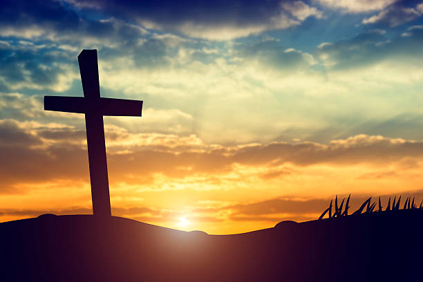 istock cross silhouette on the mountain at sunset 609816194
