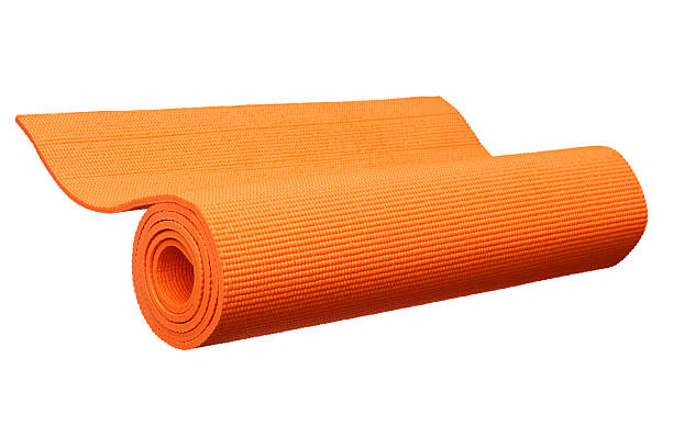 Orange yoga mat isolated on white