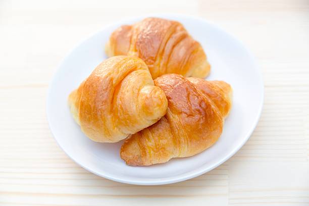 istock Croissant bread on white plate in restaurant 609819916