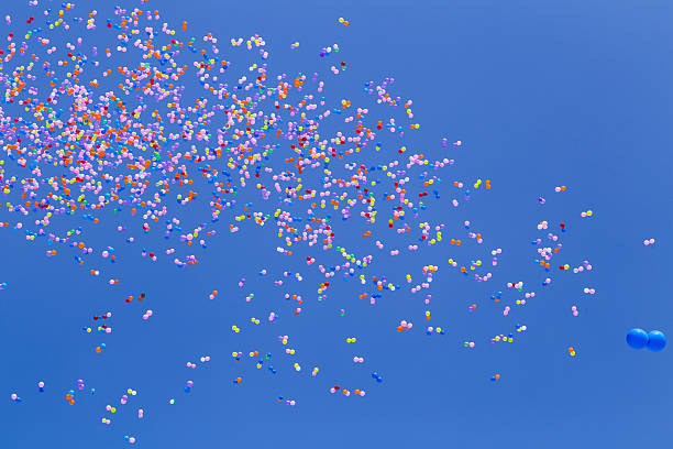 istock balloons flying in the sky 609821838