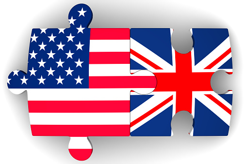 Puzzles with flags of the United States of America and the United Kingdom on a white surface. The concept of coincidence of interests in geopolitics. Isolated. 3D Illustration