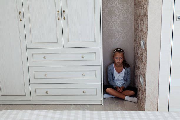 istock Little girl sitting in the corner 609822250