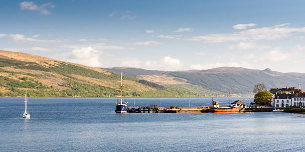 Loch Fyne Inveraray, Scotland - May 13, 2016: Traditional sailing and steam boats docked at Inveraray Pier in the sheltered waters of Loch Fyne, a fjord-like sea loch, on a summer evening in the south west Highlands of Scotland. loch fyne stock pictures, royalty-free photos & images
