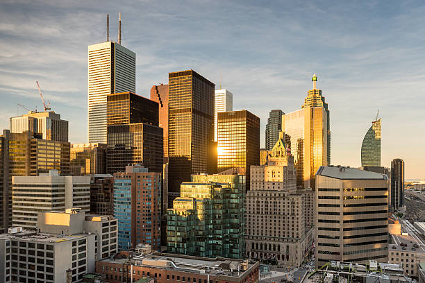 Cityscape of the financial district in Toronto, Ontario, Canada Wide angle view of warm sunlight illuminating the financial district of Toronto, Ontario, Canada. toronto skyline sunrise stock pictures, royalty-free photos & images