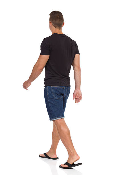istock Man Walking In Flip-Flops. Rear Side View 609823838