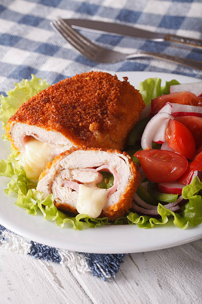 istock Delicious sliced Chicken cordon bleu and a salad 609826020