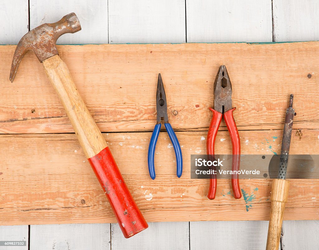 Hammer Pliers And Soldering Iron On Wooden Background Stock Photo