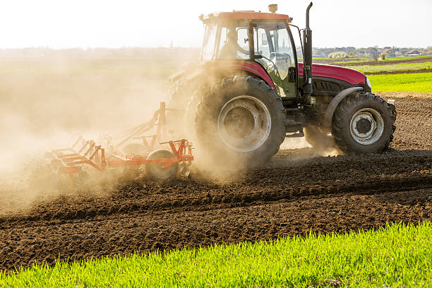 istock Farmer in tractor preparing land with seedbed cultivator. 609827698