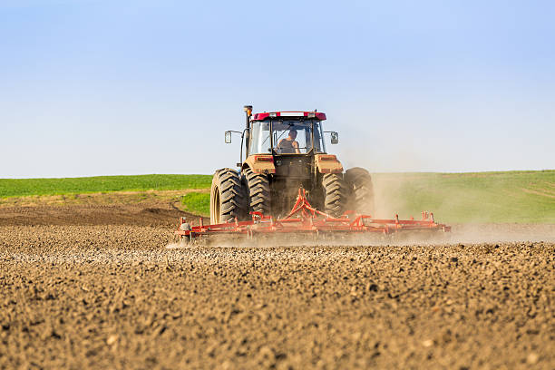 istock Farmer in tractor preparing land with seedbed cultivator. 609827934