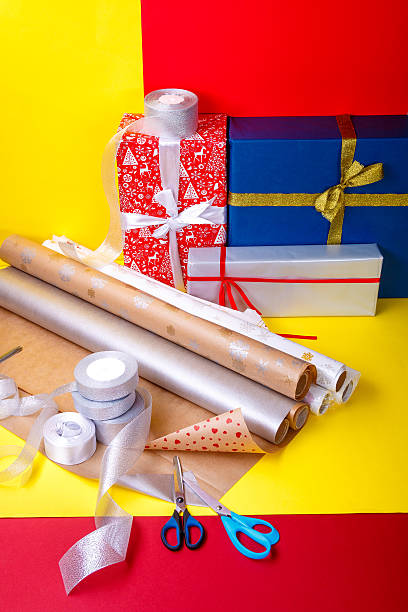 istock Gift wrapping, boxes, paper, ribbon and scissors on color background 609828348