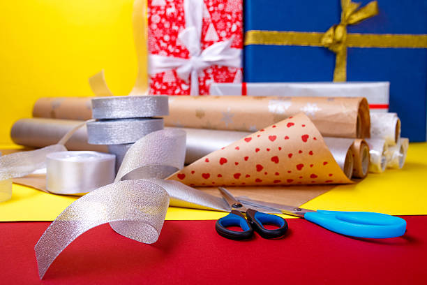 istock Gift wrapping, boxes, paper, ribbon and scissors on color background 609828670