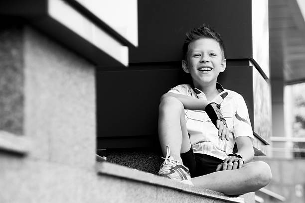 boy sitting near columns clear summer day