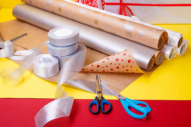 istock Gift wrapping, boxes, paper, ribbon and scissors on color background 609828760